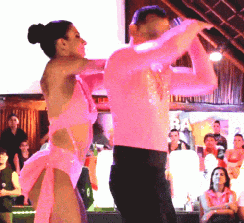 two people are performing on the dance floor