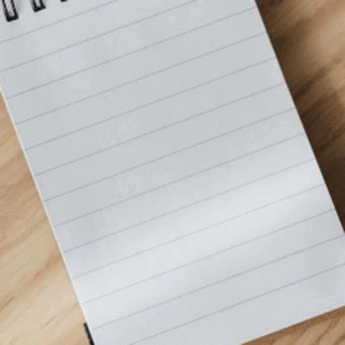 a piece of paper lying on top of a wooden surface