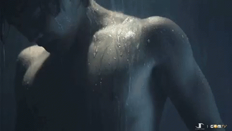 a male showering in the shower with a water splash on his back
