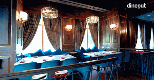 an empty dining room is shown with tall curtains