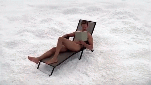 there is a person reading on the lawn chair