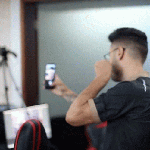 a person using their cell phone as he takes a picture of himself