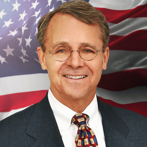 a man that is wearing a tie and glasses