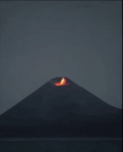 a blue flame is on the top of a mountain