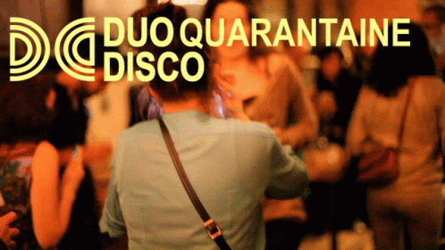 a man walks through a crowded disco while people are playing