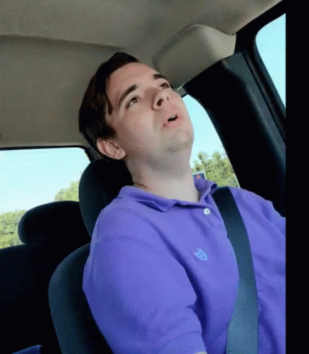 a person sitting in a car with his head up