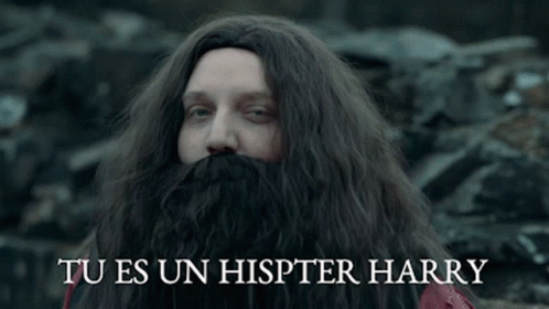 a man with long hair and a large beard with the words tu es un hister harry written in spanish