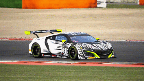 a car with a racing outfit driving around a track