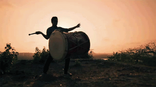 a man holding a drum by the tail