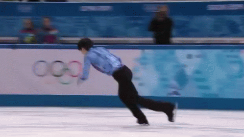 a man in black figure skating on ice