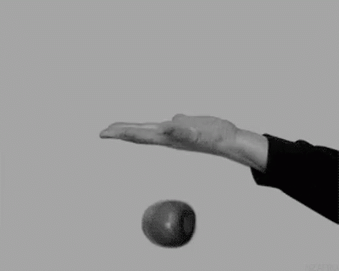 a person reaches for the ball coming from his hand