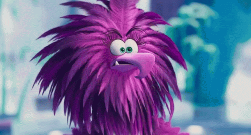 the furry purple monster is frowning and pointing