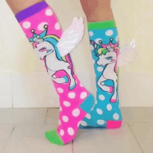 a pair of legs in polka dot stockings with unicorns on them