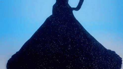 silhouette of a woman in a black dress with the back light on