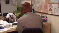 the man sits at a desk looking at the computer