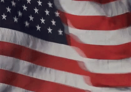 an american flag waving on a pole