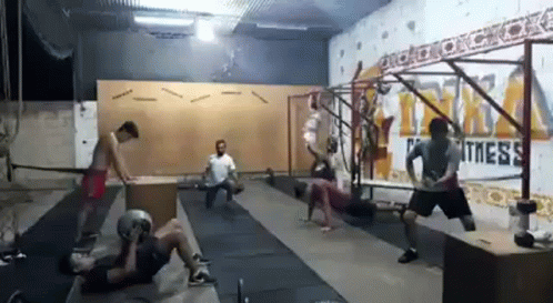 a group of people working on their moves in an empty room