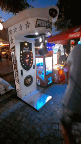 a man looking at a street vending machine