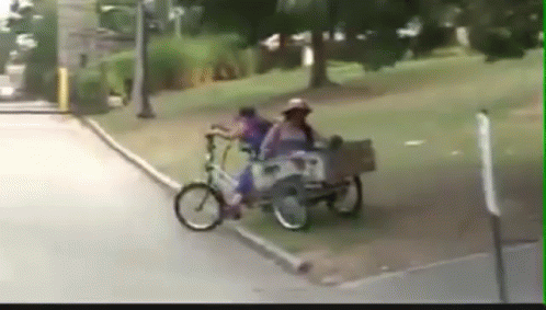 there is a picture with a person on a bicycle pulling a cart with two people