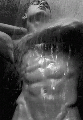 a man is spraying water off his torso
