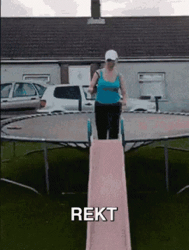 a woman standing on top of a table with a tennis racquet