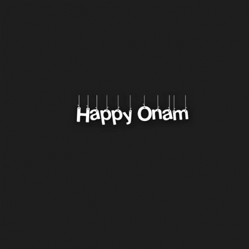 the word happy onam in white letters hanging from strings