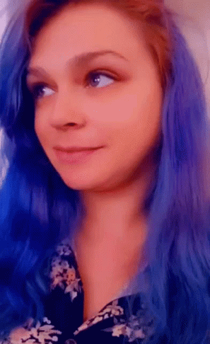 red haired girl with blue make - up is seen in this picture