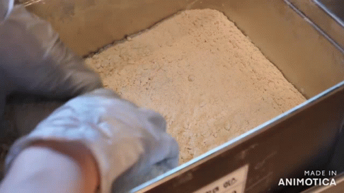 someone making sand and water from a paper towel