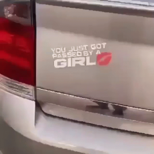 a car with a sticker on it's side that says you just got passed a girl