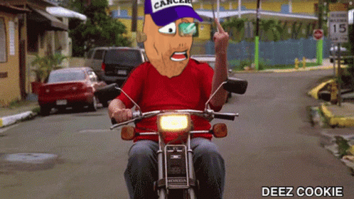 a man in a blue shirt and red hat is riding a motorcycle