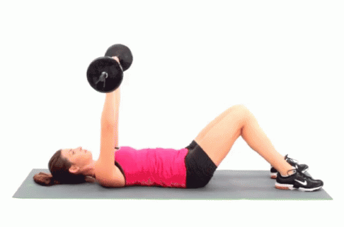 a girl on a mat doing exercise with a barbell