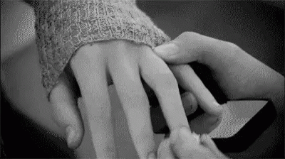 two hands are holding each other's wrist