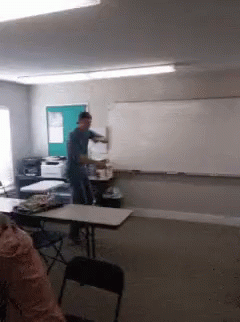 a man in a classroom using a computer