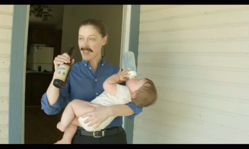 a man holding a baby and holding a bottle