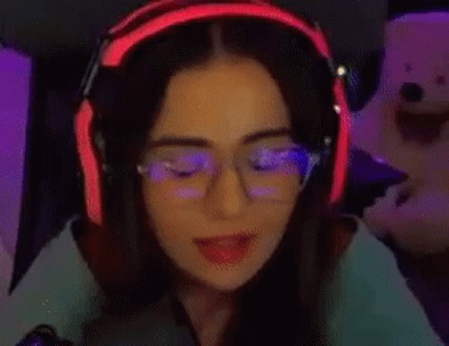 the girl with headphones and glasses has glowing light on