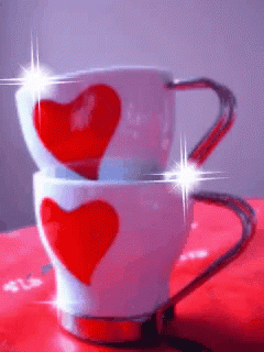 two mugs that have hearts drawn on them