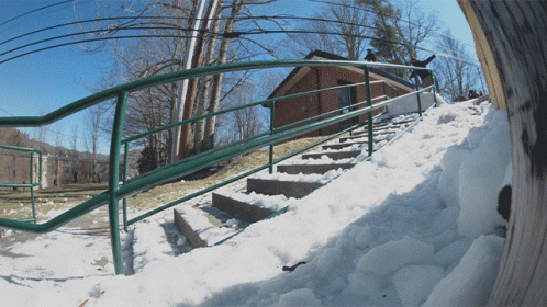 snow covered steps lead down to an outdoor ski area
