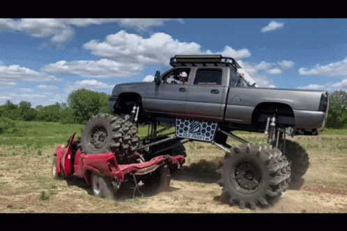 a truck with four tires riding across a field