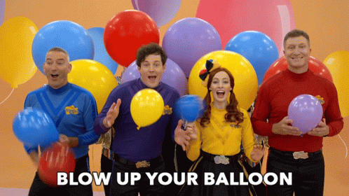 group of people dressed up and posing with balloons