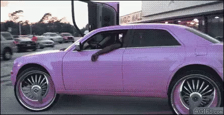 a bright pink car is parked in the parking lot