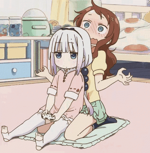 two anime characters are sitting in a room