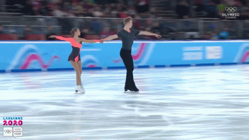 two figure skaters performing a professional skating maneuver