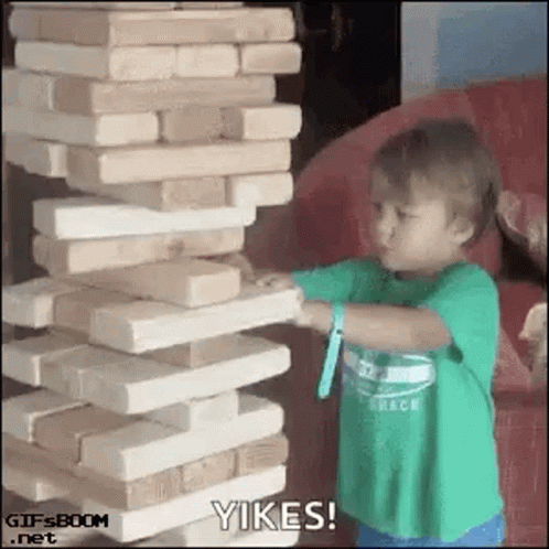 small child with arm extended and a lot of blocks