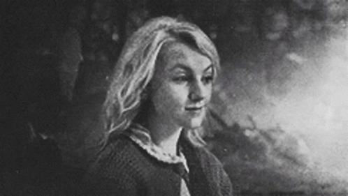 black and white pograph of a woman with blonde hair looking back
