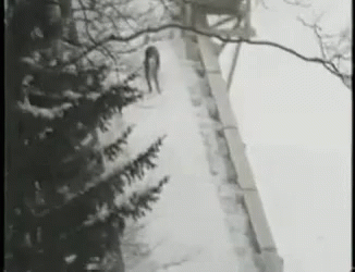 a lone figure is walking down a bridge