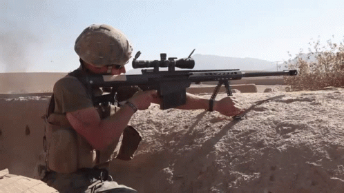 a soldier holding an m4 rifle during a range shooting
