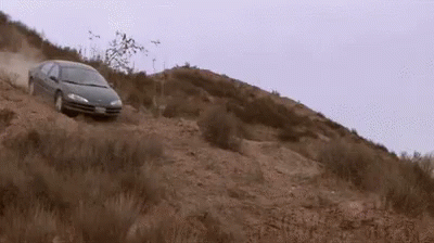a car is traveling up a small hill