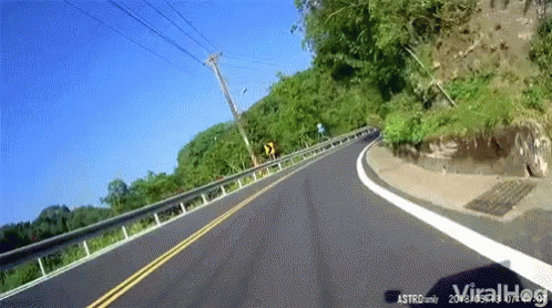 a car is driving down a road as seen from the car windshield