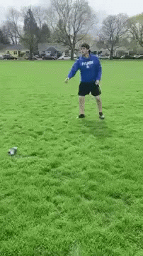 two soccer players are running around in the green grass