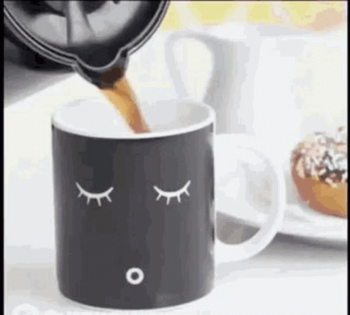 an image of a cup with a spoon on it and eyes drawn on the side